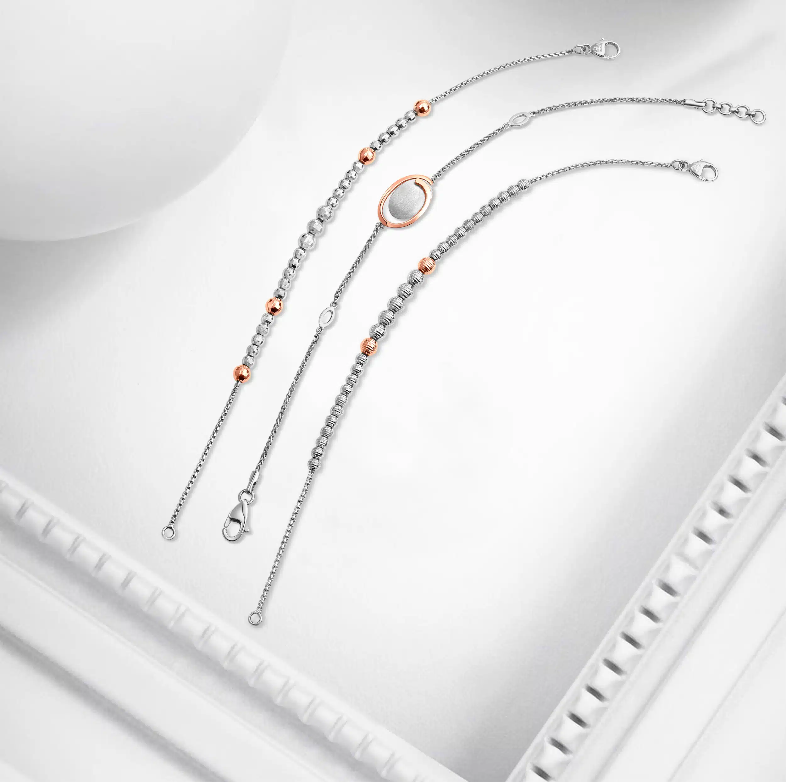Top angle photography for 3 luxury bracelets for females, photographed with a creative white props and background