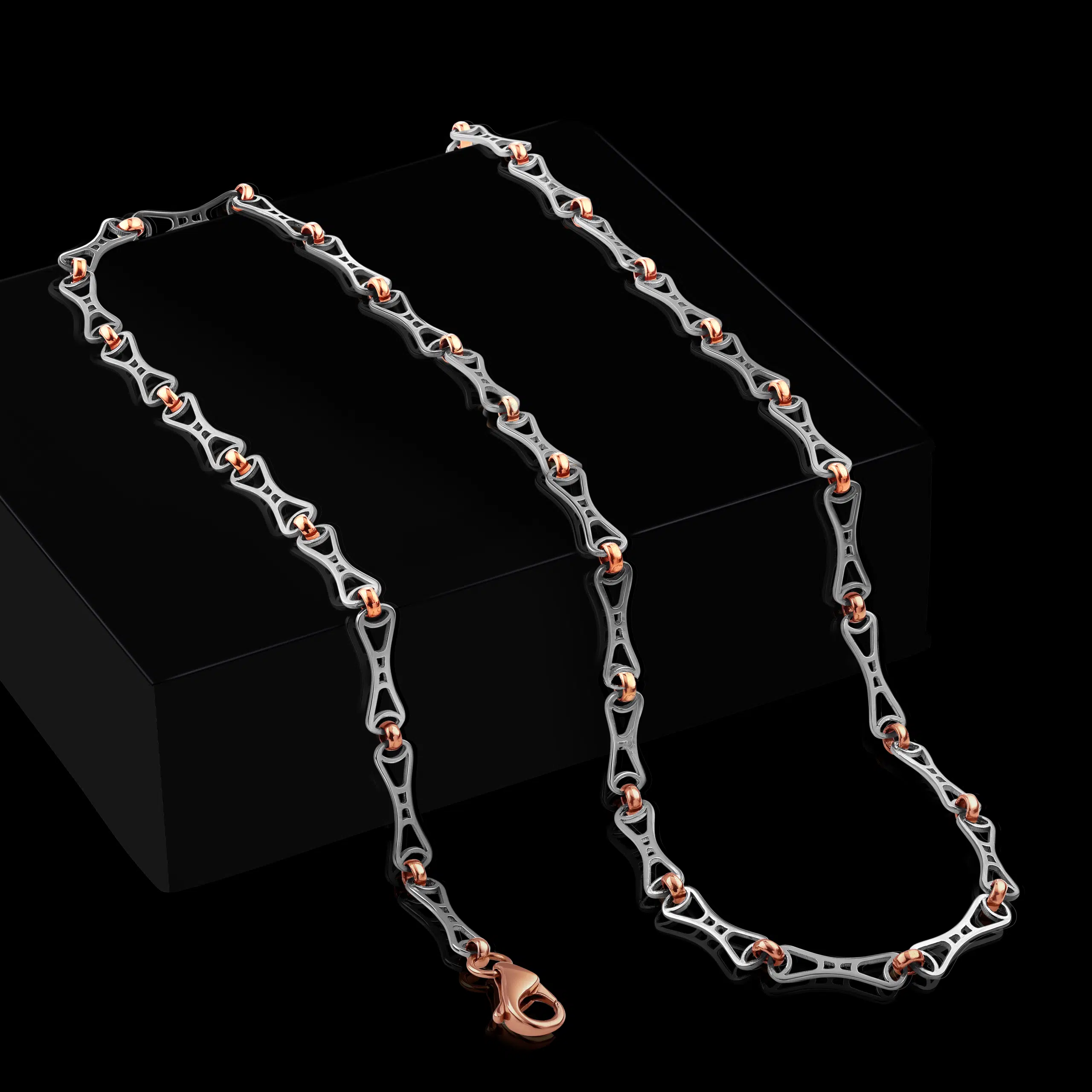 Platinum and rose gold men chain photography on creative black props and background in photo studio of mumbai