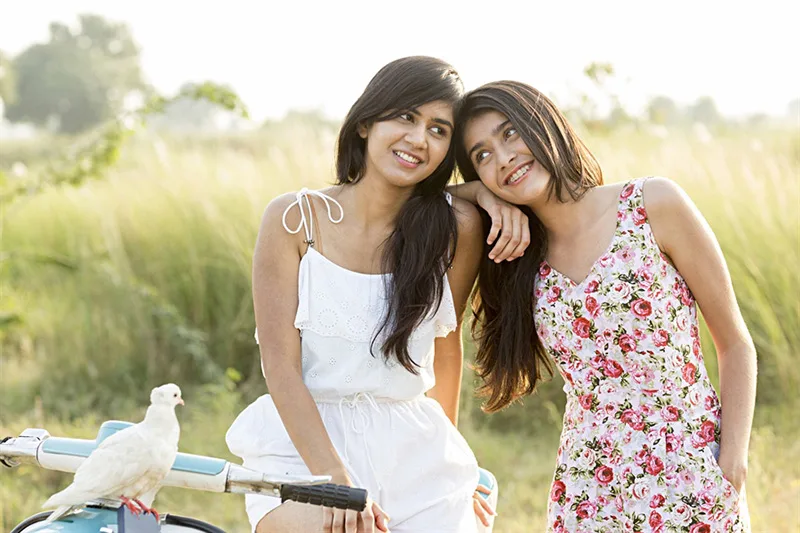 2 teenage girl happily posing for a photoshoot outdoor campaign in mumbai